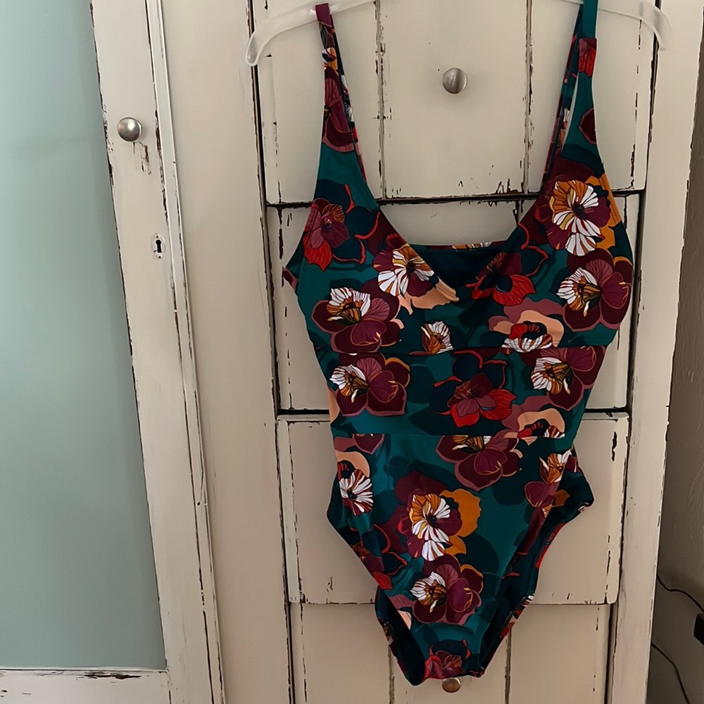 Never worn one piece suit. Size large name brand into the bleu.